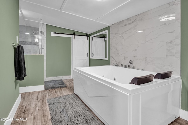 bathroom with separate shower and tub and wood-type flooring