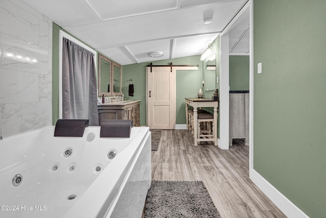 bathroom featuring a tub, vanity, wood-type flooring, and lofted ceiling