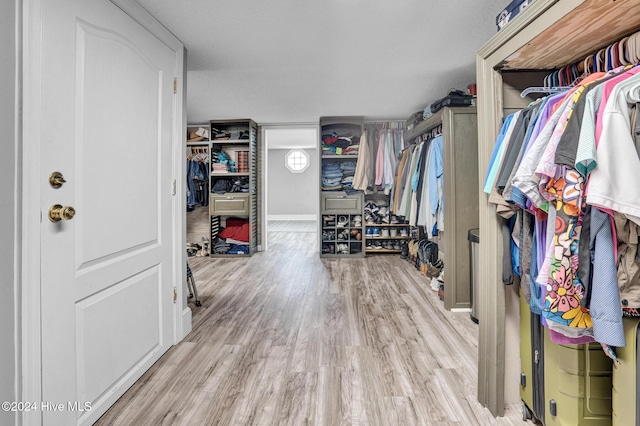 walk in closet featuring light hardwood / wood-style flooring