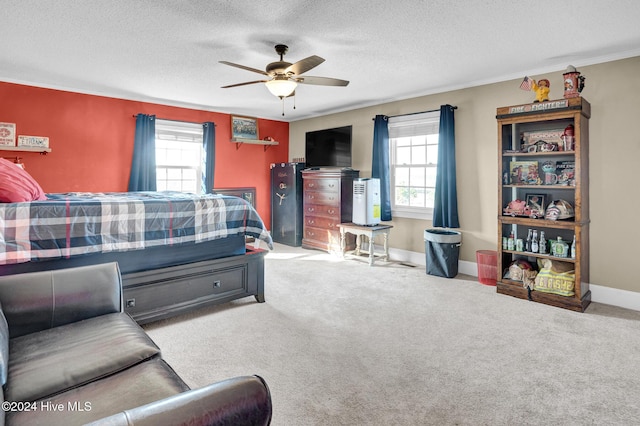 carpeted bedroom featuring ceiling fan, a textured ceiling, and ornamental molding