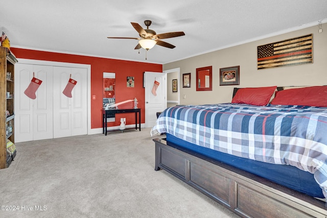 carpeted bedroom featuring a textured ceiling, a closet, ceiling fan, and crown molding