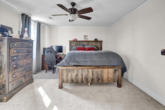 carpeted bedroom featuring ceiling fan, crown molding, and a textured ceiling