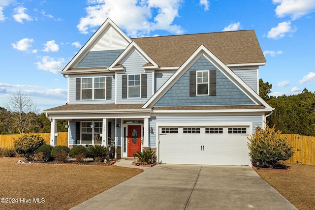 craftsman-style home featuring a garage and a front lawn