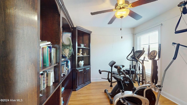 workout area featuring ceiling fan and light hardwood / wood-style flooring