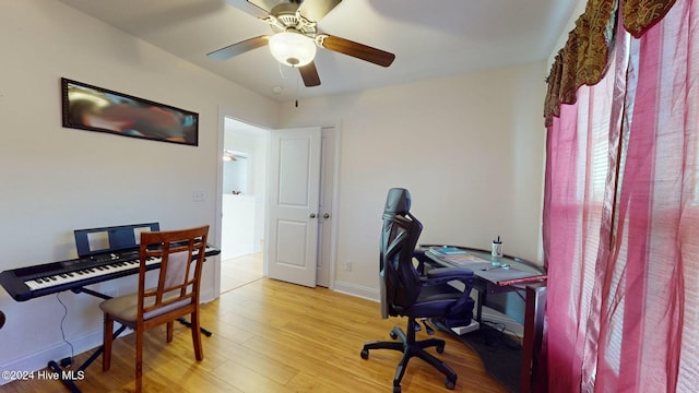 home office with ceiling fan and light hardwood / wood-style floors