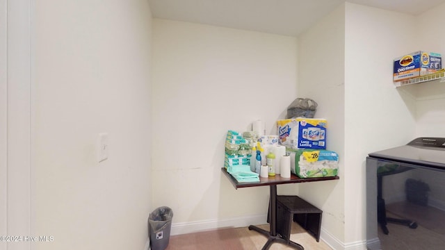 clothes washing area with light hardwood / wood-style flooring