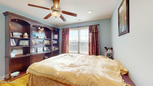 bedroom with ceiling fan and light wood-type flooring