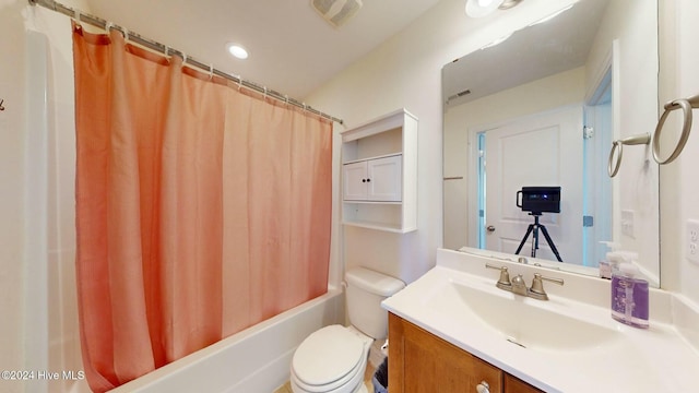 full bathroom featuring shower / bath combo, vanity, and toilet