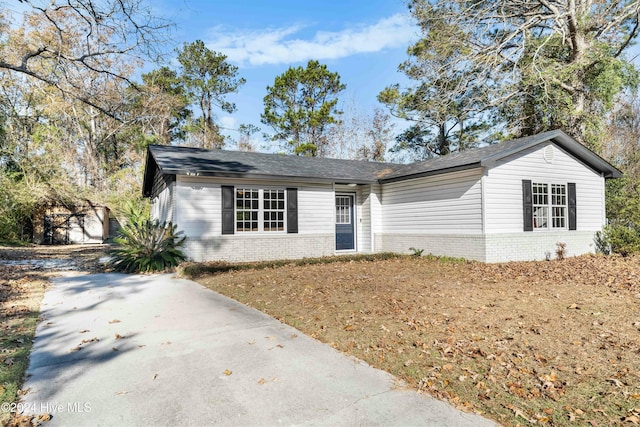 ranch-style home with a garage and an outbuilding