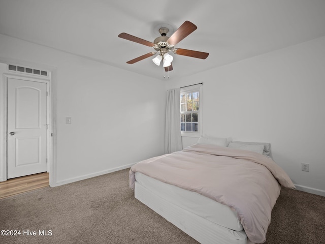 carpeted bedroom with ceiling fan