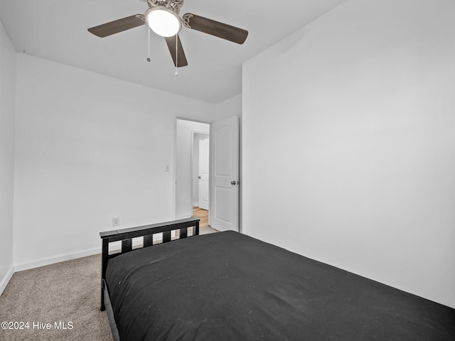 bedroom with light carpet and ceiling fan