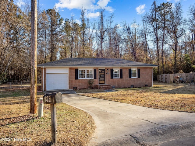 single story home featuring a garage and a front lawn