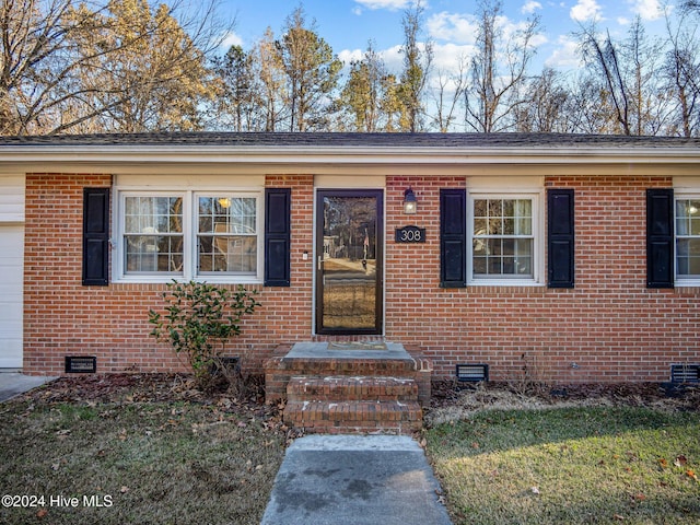 view of exterior entry featuring a garage