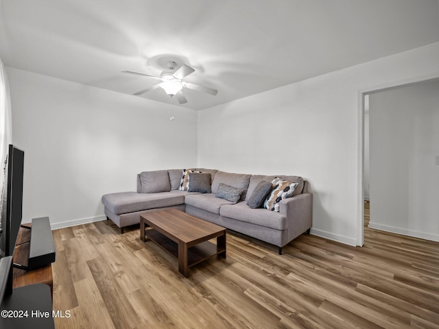 living room featuring ceiling fan and light wood-type flooring