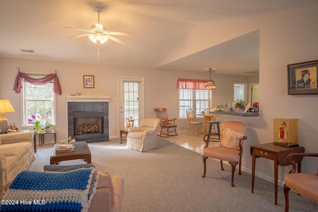 living room featuring plenty of natural light, carpet, and vaulted ceiling