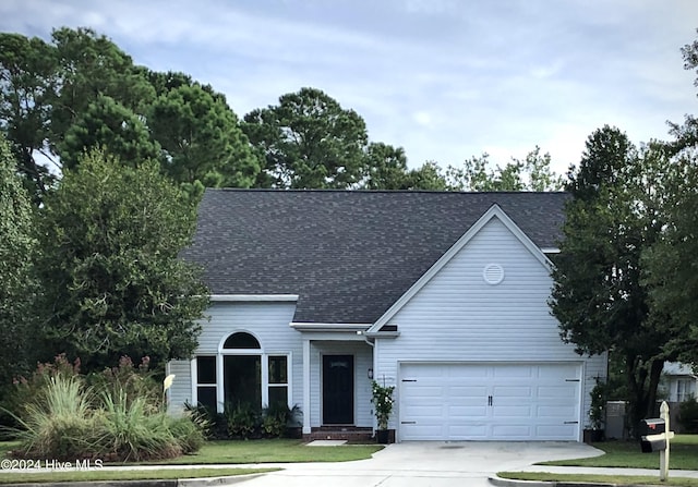 view of front of house featuring a front yard and a garage