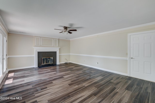 unfurnished living room featuring a fireplace, dark wood-type flooring, ceiling fan, and ornamental molding