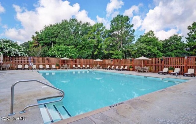 view of swimming pool with a patio