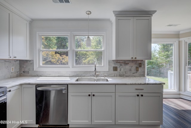 kitchen with sink, light stone counters, stainless steel dishwasher, pendant lighting, and white cabinets