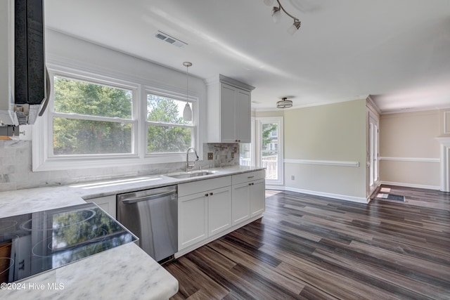 kitchen with pendant lighting, white cabinets, sink, stainless steel dishwasher, and decorative backsplash