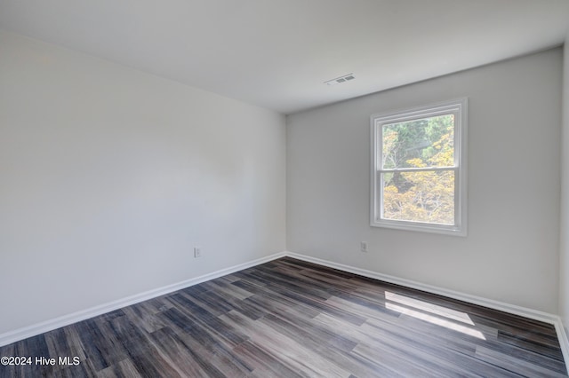 unfurnished room with dark hardwood / wood-style flooring