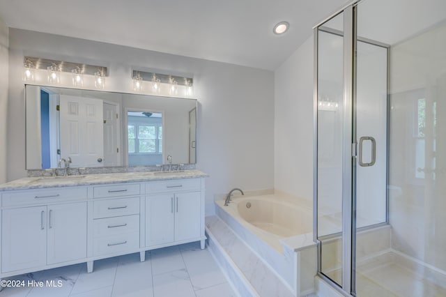 bathroom with vanity and separate shower and tub