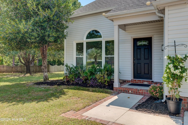 doorway to property with a yard