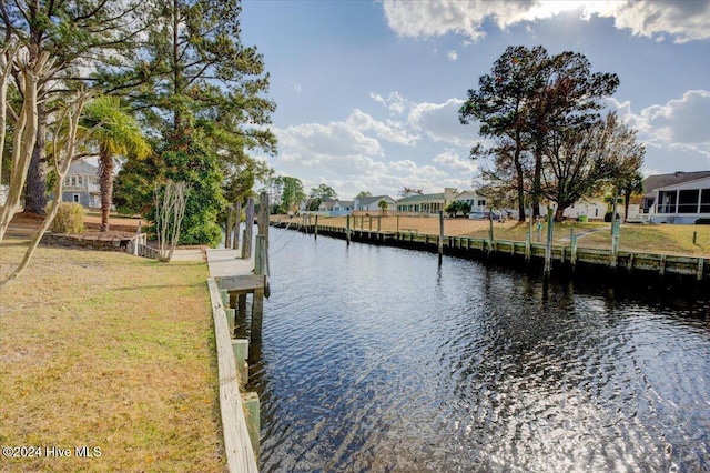 dock area with a yard and a water view