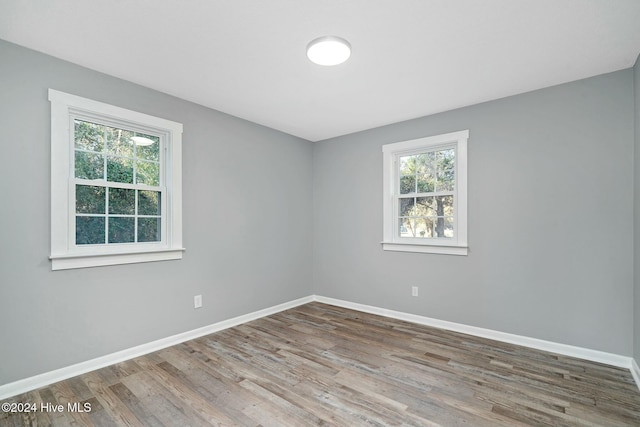 unfurnished room featuring hardwood / wood-style flooring