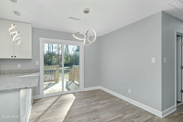 unfurnished dining area with light hardwood / wood-style flooring