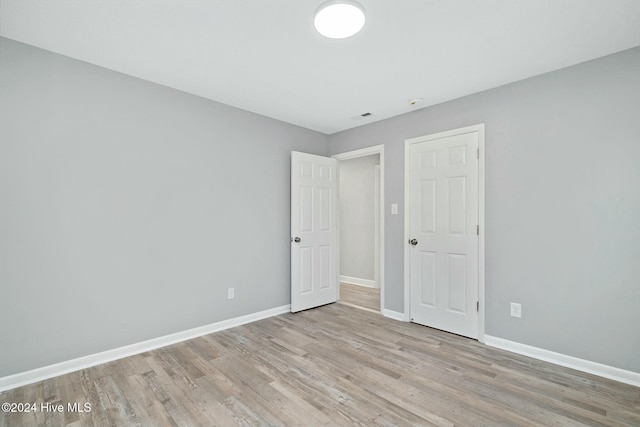 unfurnished bedroom with light wood-type flooring