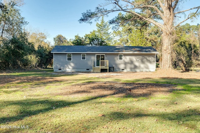 back of property featuring a yard