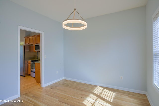 spare room with light wood-type flooring