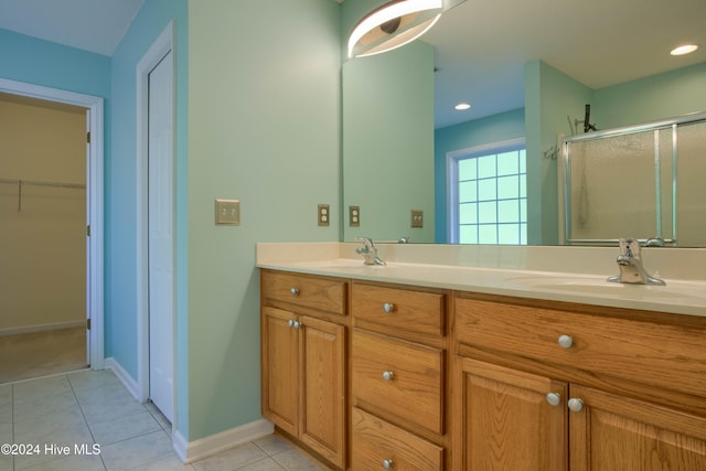 bathroom with vanity, tile patterned floors, and an enclosed shower