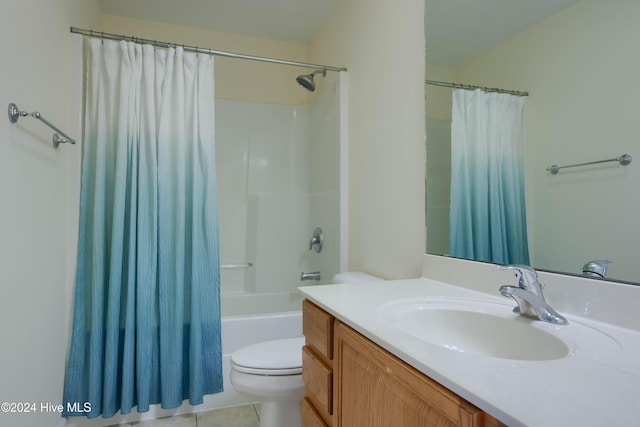 full bathroom featuring toilet, vanity, tile patterned floors, and shower / bath combo with shower curtain