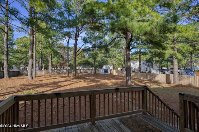 wooden deck featuring a storage shed