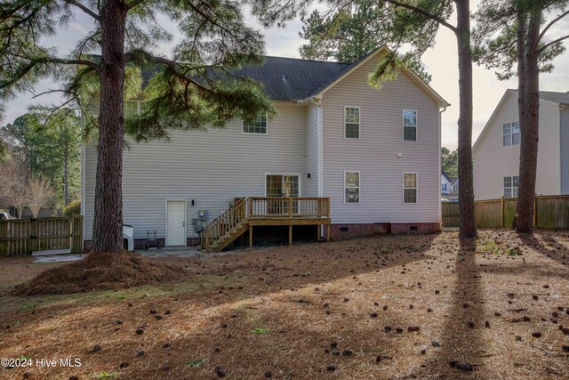 rear view of property featuring a deck