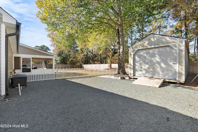 view of yard with a garage and an outdoor structure