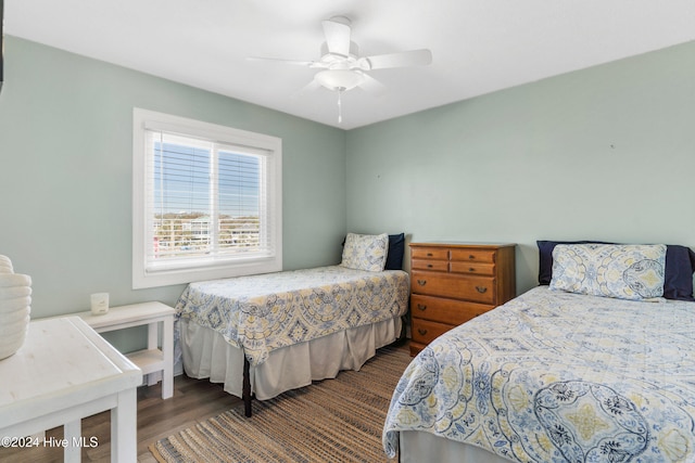 bedroom with ceiling fan and dark wood-type flooring