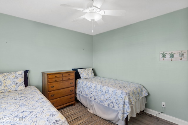 bedroom featuring ceiling fan and dark wood-type flooring