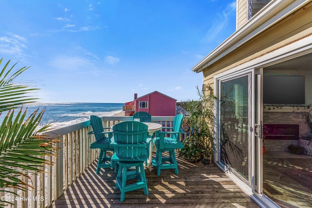 deck with a water view and a beach view