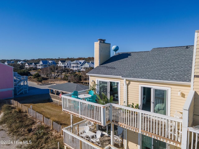 back of house with a deck