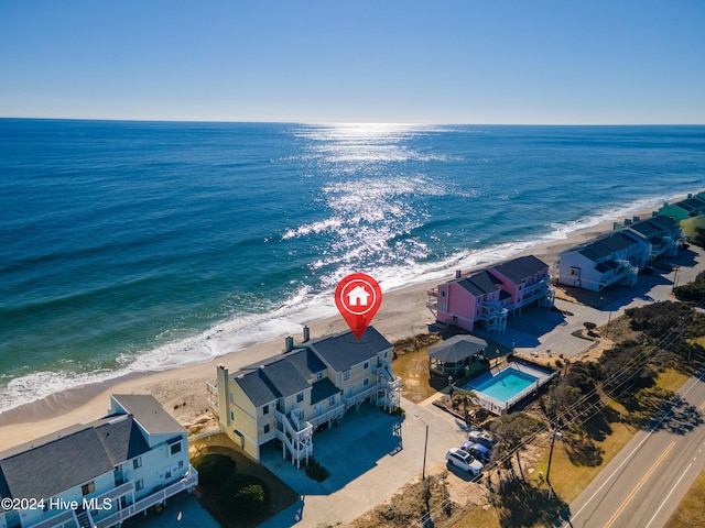 bird's eye view with a water view and a beach view