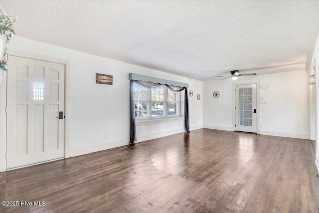 foyer with ceiling fan, dark wood-type flooring, and a textured ceiling