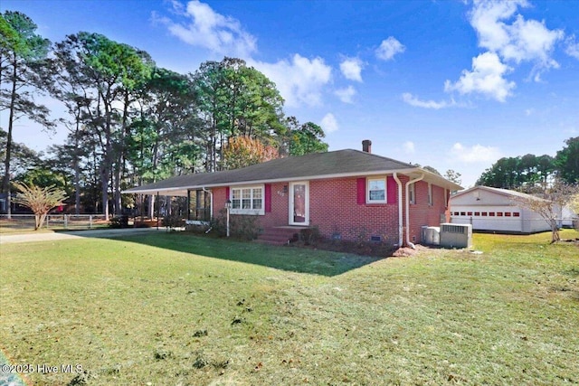 view of front of house with an outbuilding, a garage, a front yard, and cooling unit