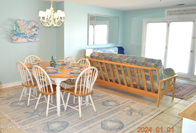 tiled dining area with a healthy amount of sunlight and a chandelier