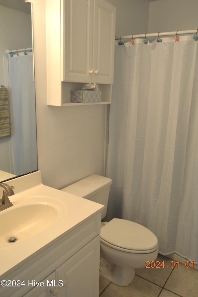 bathroom with tile patterned floors, vanity, and toilet