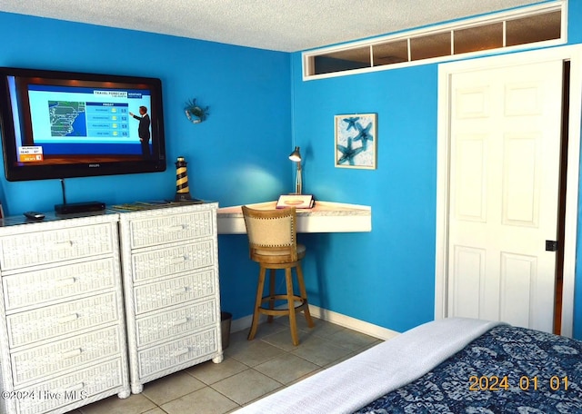 tiled bedroom with a textured ceiling