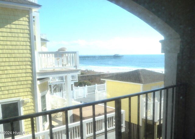 balcony with a water view and a beach view