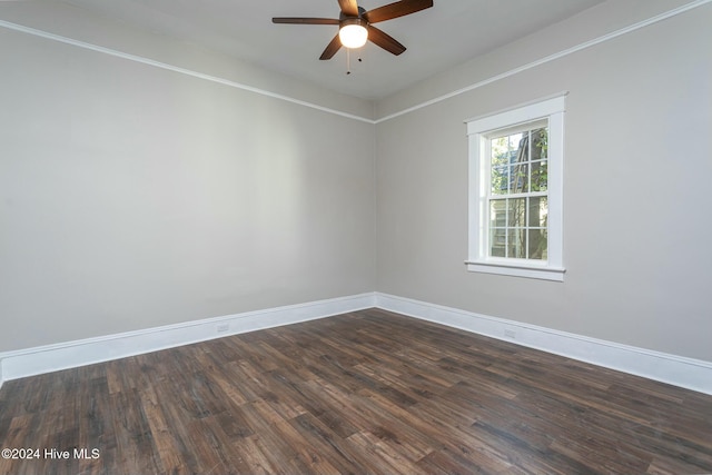 spare room with dark hardwood / wood-style floors and ceiling fan